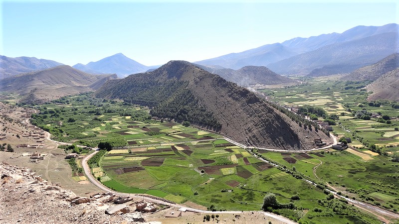 A trekker on a High Atlas ridge above a Berber village