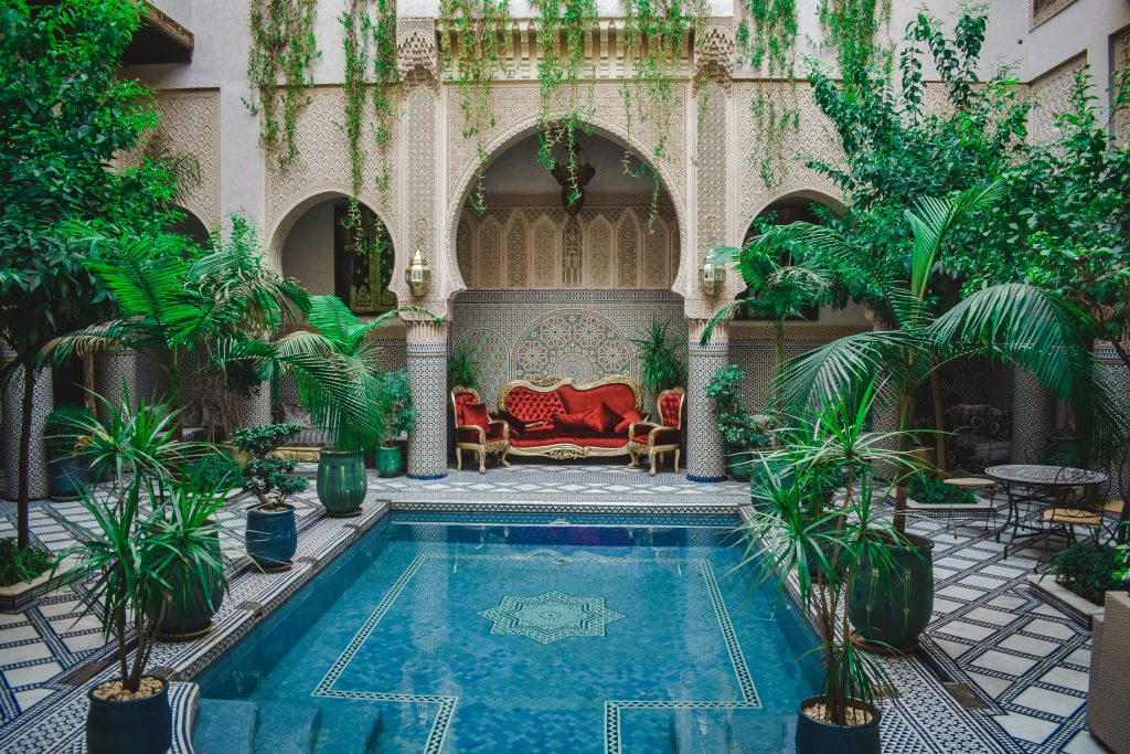 Luxury riad courtyard with a pool and palms in Marrakech