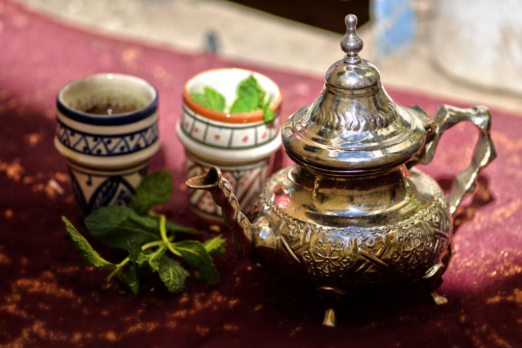 Moroccan mint tea poured into a traditional glass