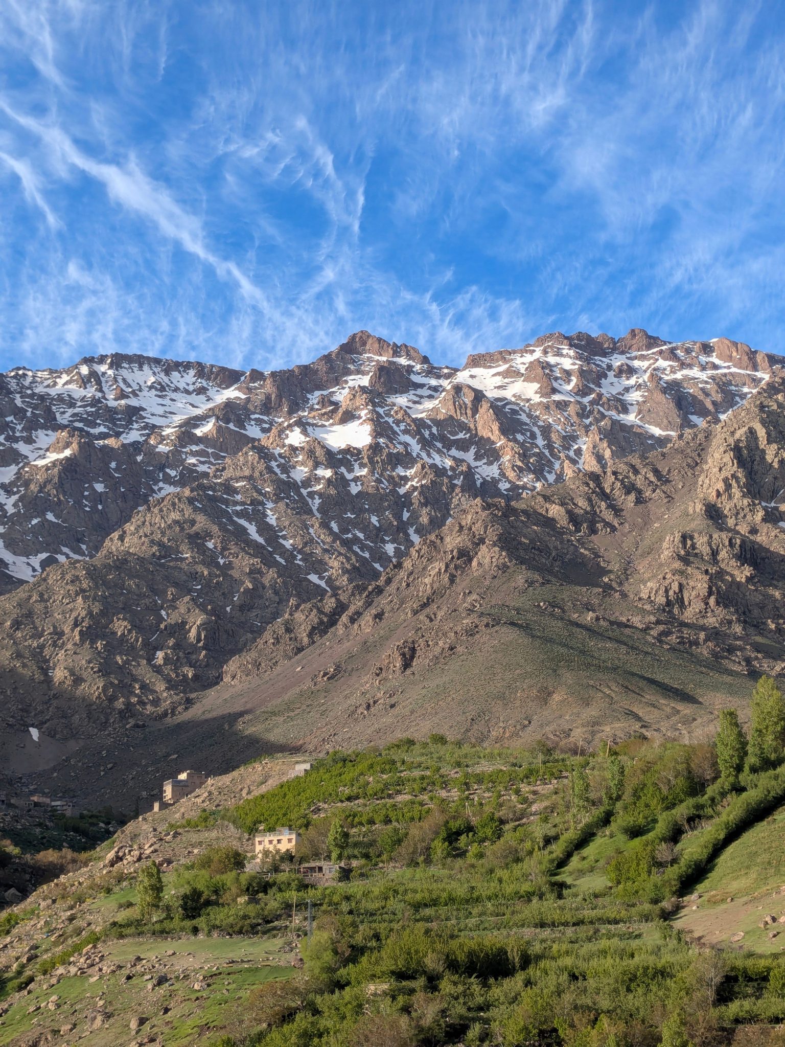 The snow covered Toubkal massif rising above the Imlil valley