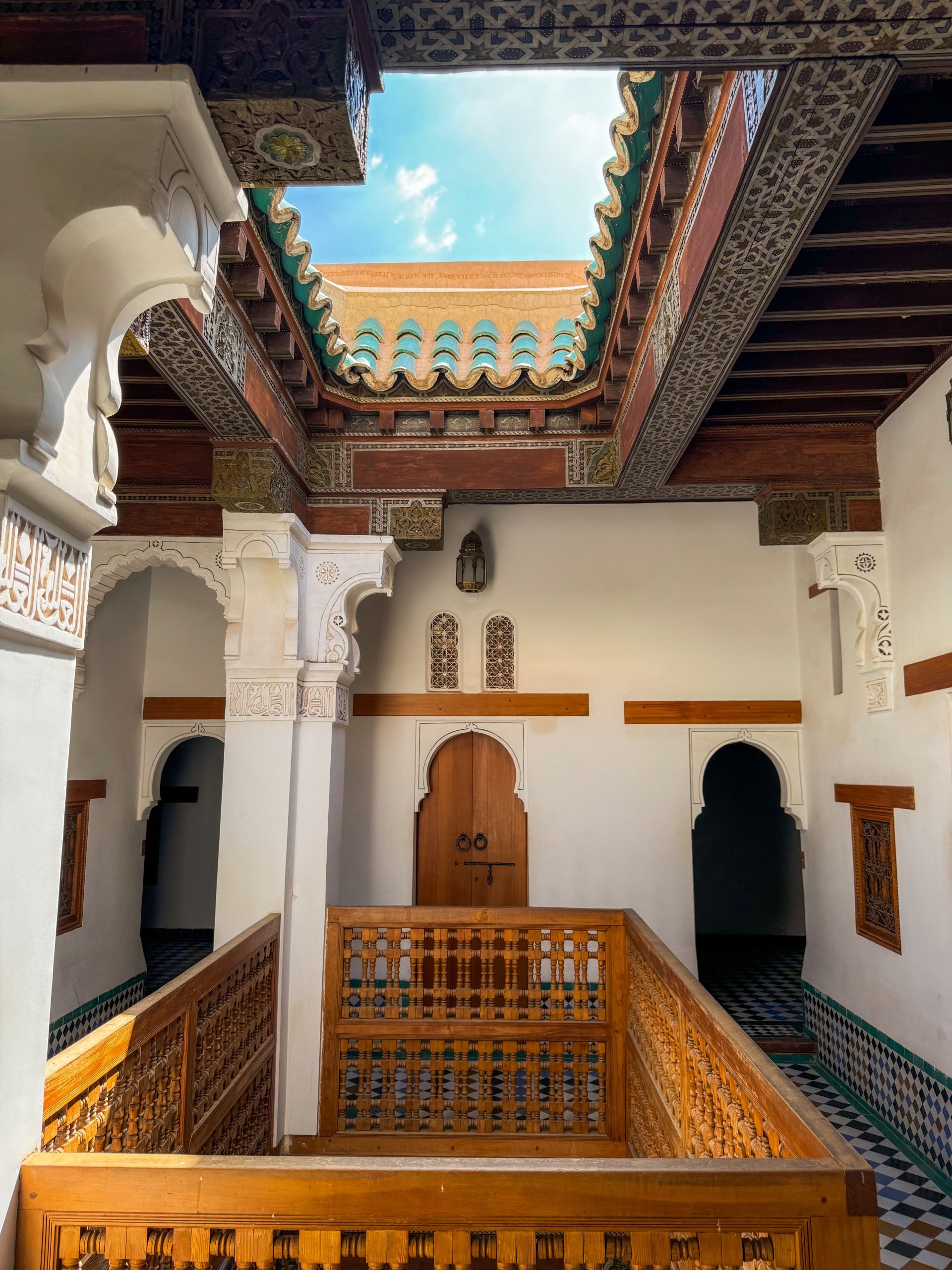 A riad courtyard in the Marrakech medina with carved cedar and zellige