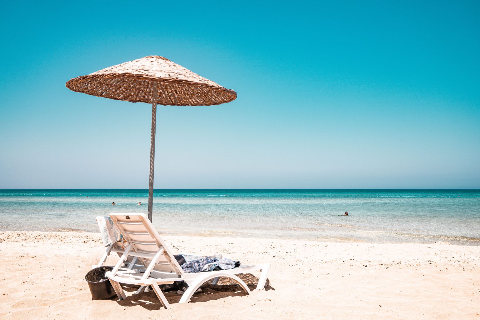 A parasol and lounger on a quiet Moroccan beach in August